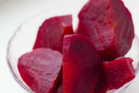 Boiled beets cut into pieces in a plate closeup.の写真素材