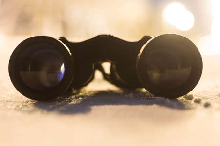 Binoculars closeup in the winter season. Evening time of day.
