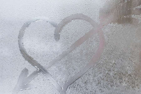 Rainy weather, the inscription heart on the sweaty glass