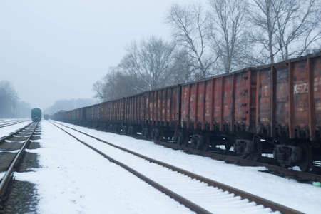 Gloomy railroad in the winter time of the year with snow.の写真素材