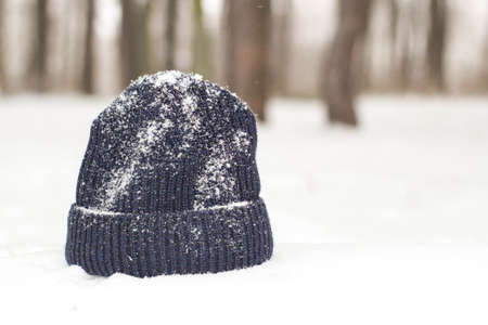 Winter men's hat close up in snowy weather.の写真素材