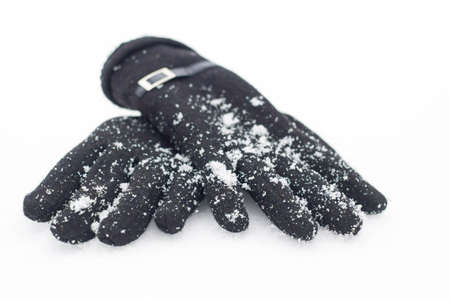 Women's gloves in snowy weather close up.の写真素材