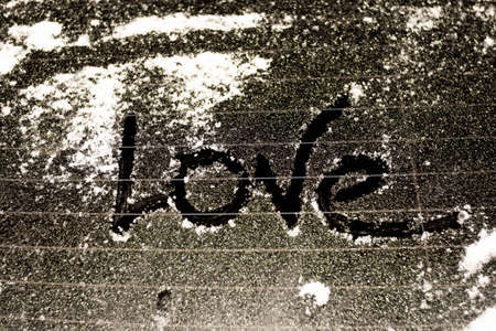 frozen car glass on a winter day with the words i love you.の写真素材