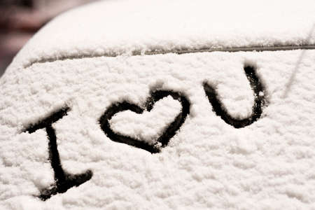 frozen car glass on a winter day with the words i love you.の写真素材
