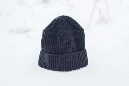Winter men's hat close up in snowy weather.の写真素材