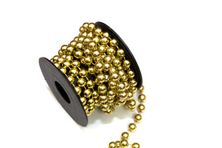 the coil is wrapped with bead thread, decoration closeup on a white background.の写真素材