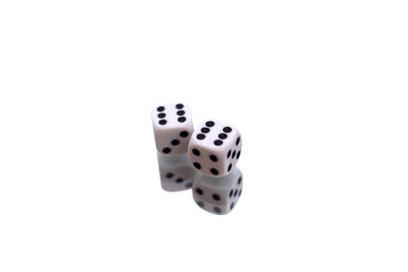 Gambling dices falling down against white backgroundの写真素材