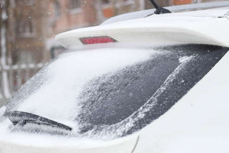frozen car glass, car glass in ice with snow, frost, snowfall.の写真素材