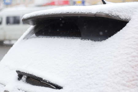 frozen car glass, car glass in ice with snow, frost, snowfall.の写真素材
