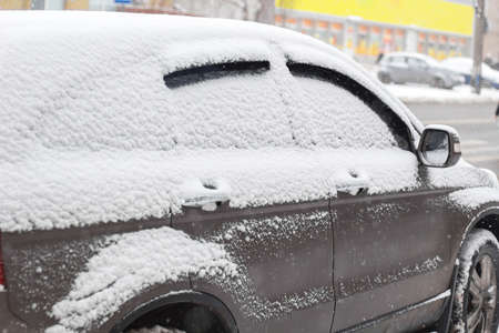 frozen car glass, car glass in ice with snow, frost, snowfall.の写真素材