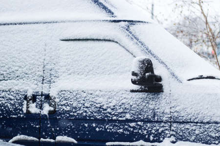 frozen car glass, car glass in ice with snow, frost, snowfall.の写真素材