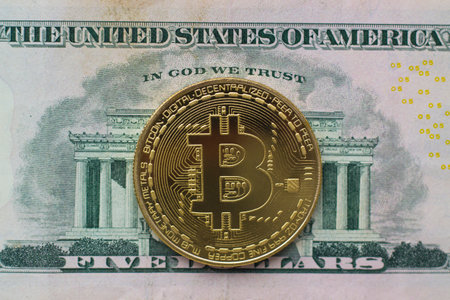 Bitcoin coin on dollar bill closeupの写真素材