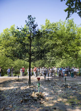 Peterhof, Saint-Petersburg, Russia - July 6,2015: Fountain- joke with the time of Peter the most incredibly fun "game" offers the Lower Park.Visitors to the park looking at the child playing with a fountainのeditorial素材