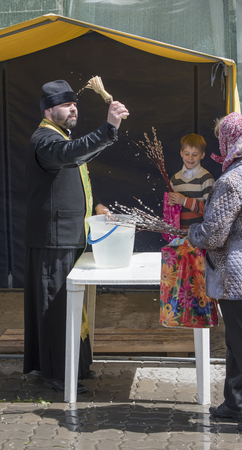 ROSTOV-ON-DON, RUSSIA- APRIL 24 -On Palm Sunday people are recruited into the church to the priest...
