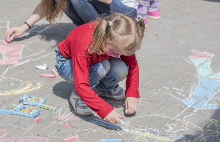 Rostov-on-Don, Russia- May 22,2016: Girl in fancy dress draws on the sidewalk at the festivalのeditorial素材