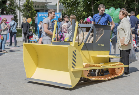 Rostov-on-Don, Russia- May 22,2016: Pram in the form of a tractor at the carnival