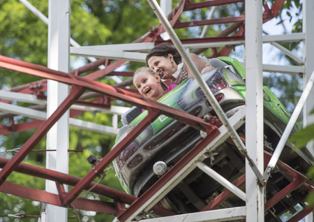 Rostov-on-Don, Russia- June 13: Girl with mum ride attraction "Rollercoaster"のeditorial素材