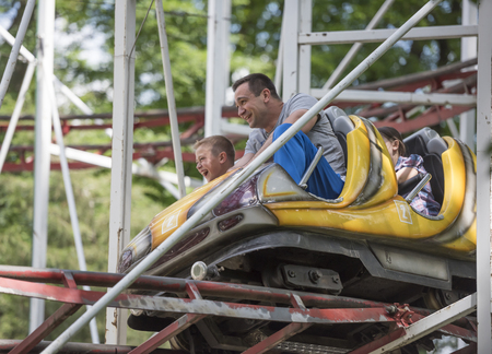 Rostov-on-Don, Russia- June 13: Children with father ride the ride "roller coaster"のeditorial素材
