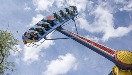 Rostov-on-Don, Russia- June 13: Brave citizens ride the attraction "Kamikaze" in amusement parkのeditorial素材