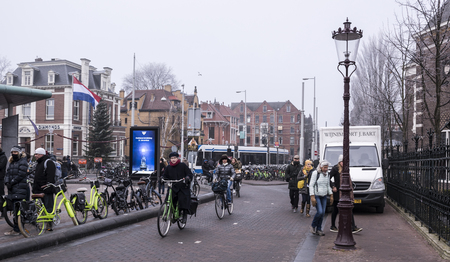 Amsterdam, Netherlands- December 30,2016: In the streets of the ancient city tourists move and transportのeditorial素材