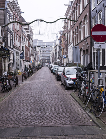 Amsterdam,the Netherlands-December 30,2016:On the street walking people and moving vehiclesのeditorial素材