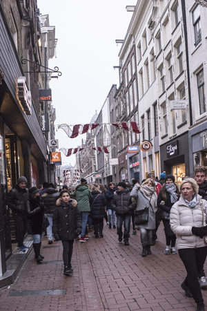 Amsterdam,the Netherlands-December 30,2016:On the street walking people and moving vehiclesのeditorial素材
