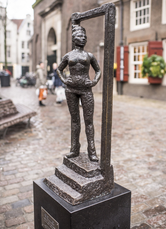 Amsterdam,Netherlands-December 30,2016: Monument wayward prostitutes is set next to the Oude Kerk church, the oldest in Amsterdam. This composition is the first and only in the world officially recognized monument prostituteのeditorial素材