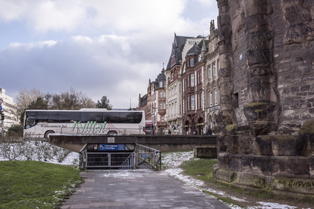 Trier,Germany- January 03, 2017: Porta Nigra (Black Gate) - the biggest and most well-preserved ancient gates worldwide.Not far walking tourists and car ridesのeditorial素材
