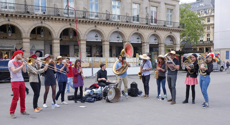 Paris,France- April 29, 2017: Performance of the brass band on Rivoli Street. On the street pedestrians and transportのeditorial素材