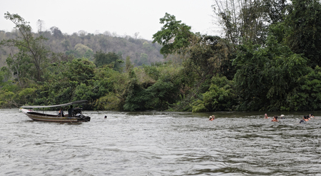 Kanchanaburi,Thailand- February 19,2018: Tourists float in lifejackets on the river Kwaiのeditorial素材