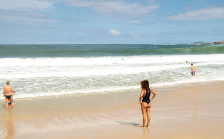 Rio de Janeiro, Brasil-  February 28, 2020: Citizens swim and sunbathe on the beach of Copacabanaのeditorial素材