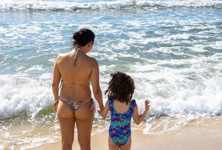 Rio de Janeiro, Brasil- March 05, 2020: Mom with daughter on the beach of Copacabanaのeditorial素材