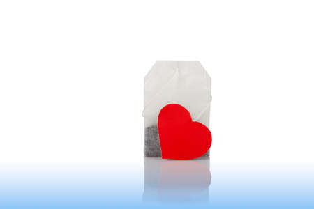 Close-up of tea bag with red heart tag on the mirror surface