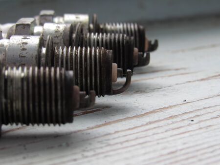 four used spark plugs for auto