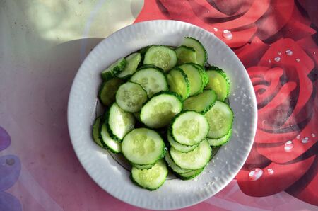 full bowl of cucumbers on the tableの写真素材