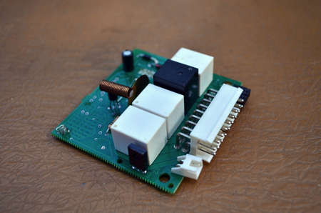 Used chip from car alarm on wooden table