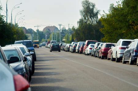 Photo of cars parked on both sides of the road