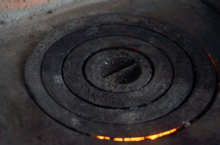 Fire under a cast iron stove with circlesの写真素材