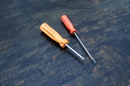 two screwdrivers on a wooden tableの写真素材