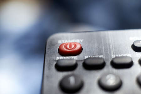 The red power button on the TV remote. selective focus.の写真素材