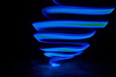 Fantastic blue light tornado in the dark, abstractの写真素材