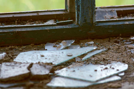 Broken glass on the windowsill of an abandoned buildingの写真素材