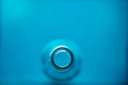 Photo of glass bottle neck. blue background.の写真素材