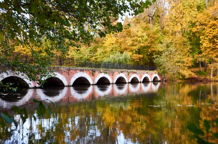 Old stone bridge over river in autumn