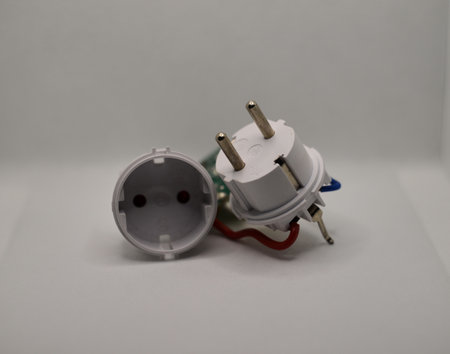 White electrical plug and socket on white background