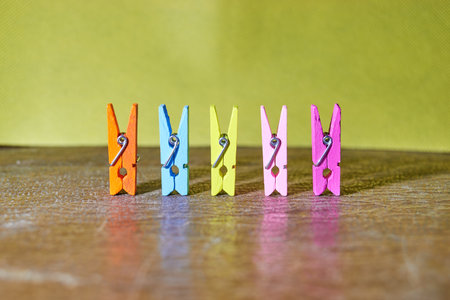 Photo of five colored clothespins on the tableの写真素材