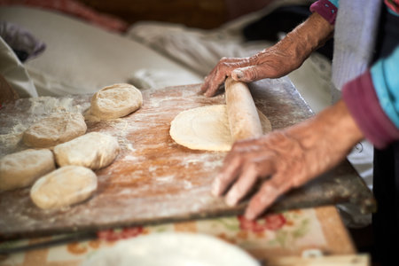 Woman preparing dough on wooden tableの写真素材
