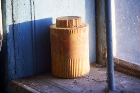 Old yellow plastic jar on the windowsillの写真素材