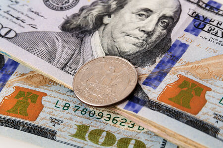 US Currency with one quarter coinsの写真素材