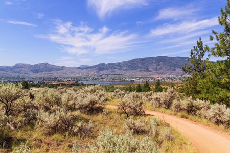 Landscape with mountains, lake and blue sky with tiny clouds.の写真素材